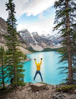 Young man jumps into the air and stretches his arms in the air