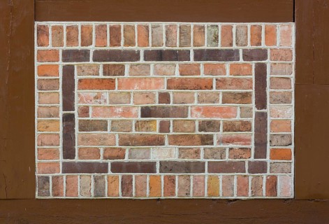 Pointing stones as patterns on the church wall in half-timbering