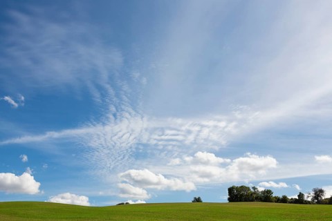 Hilly landscape and cirrus clouds in the sky