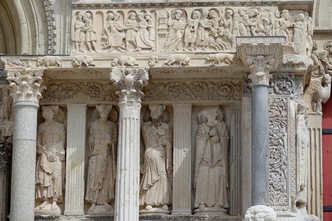 Columns and statues of saints between north portal and main portal