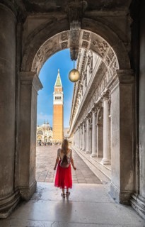 Young woman in portico at St. Mark's Square