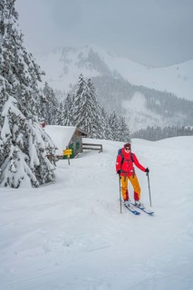 Young woman on ski tour in snowfall