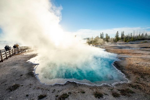 Steaming hot spring with turquoise water in the morning sun