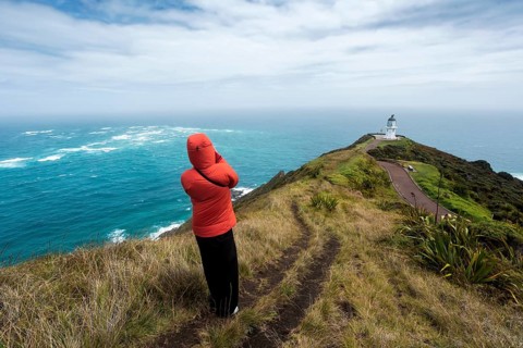 Guy infront of Cape Reinga Lighthouse