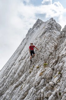 Young man at a rock face