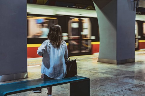 Girl sitting on the bench at metro station