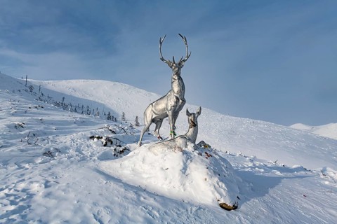 Deer monument on a snow covered mountain pass