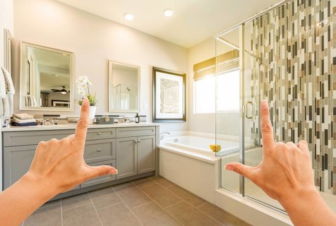 Hands framing custom master bathroom interior