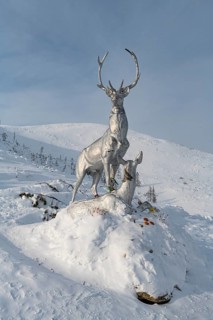 Deer monument on a snow covered mountain pass
