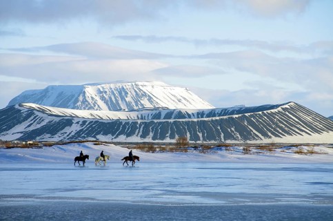 Riders in front of on partly frozen lake Myvatn