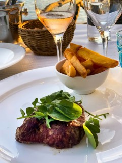 Grilled fillet steak in the evening sun by the sea