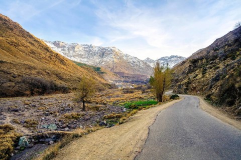Beautiful valley with stream in Atlas mountain by sunset