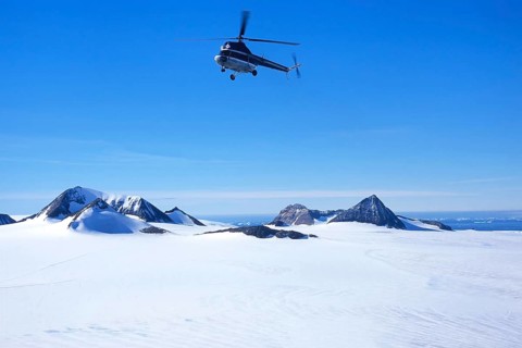 Helicopter flying over Brown Bluff in Antarctic Sound