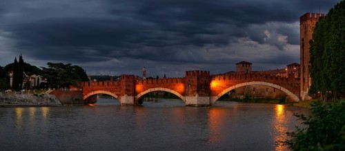 River Adige with the stone bridge Ponte Scaligero at sunset
