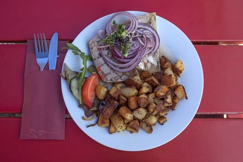 Brawn served with fried potatoes in a garden restaurant
