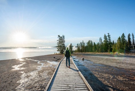 Hiker on boardwalk at West Thumb of Yellowstone Lake