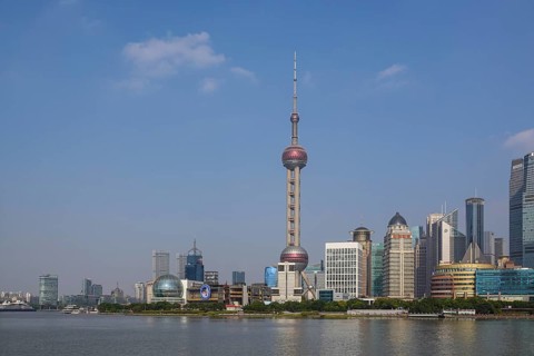 View over the Huangpu River to the skyline of the special economic zone Pudong with Oriental Pearl Tower