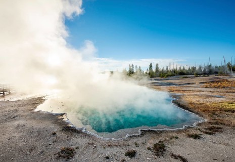 Steaming hot spring with turquoise water in the morning sun