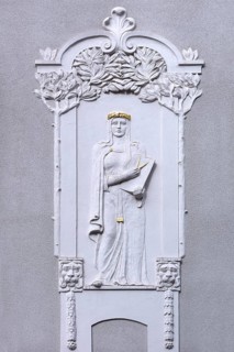 Art Nouveau relief of a woman with compasses on a residential house from 1908