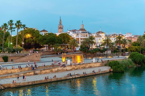 Waterfront Muelle de la sal at the river Rio Guadalquivir with Monumento a la Tolerancia