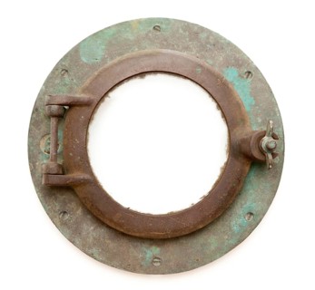 Aged antique ship porthole isolated on a white background with clipping path -inner and outer