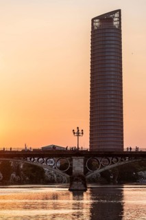 Rio Guadalquivir with bridge Puente de Triana and skyscraper Torre Sevilla