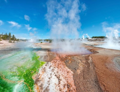 Red mineral deposits and green algae at a thermal spring