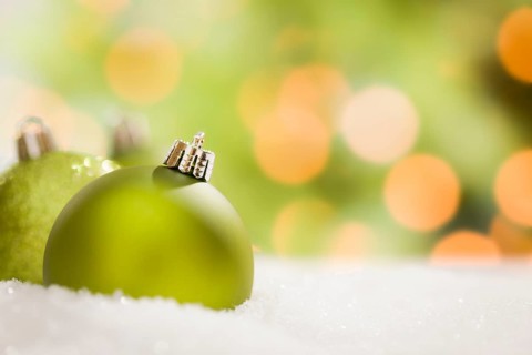 Beautiful matt green christmas ornaments on snow flakes over an abstract background with room for your own text