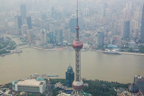 View from the highest observatory of the world on 562 meters height in the 632 meters high skyscraper Shanghai Tower on the special economic zone Pudong with the 468 meters high Oriental Pearl Tower t...