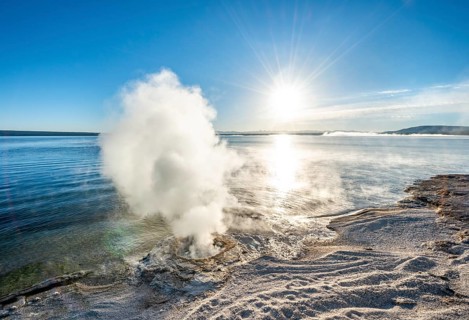 Steaming fumarole at the lake with morning sun