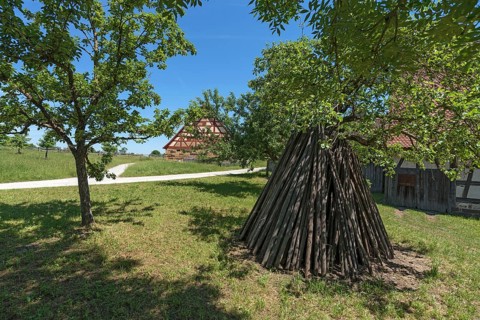 Tent-like arranged wooden poles