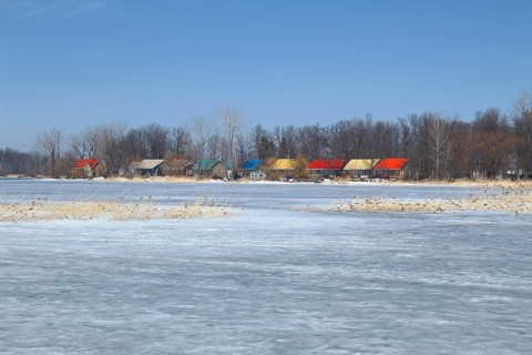 Colourful cottages on the frozen Saint Lawrence River