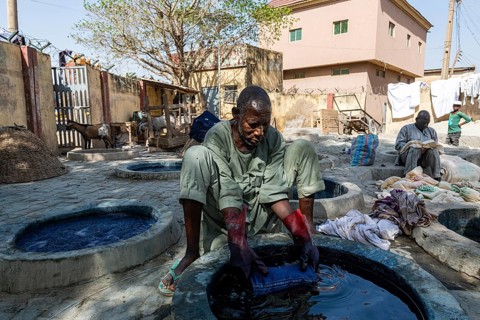 Man dyeing cllothes with Indigo