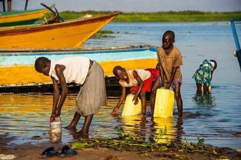 Children filling water in canisters at Lake Albert