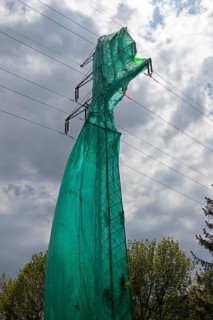 High voltage pylon covered with a tarpaulin due to maintenance work