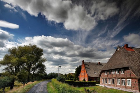 Thatched hall houses in the marshland village of Konau