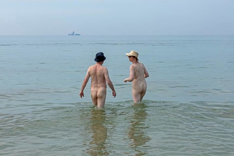 Elderly couple bathing naked