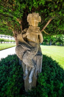 Statue under a tree in the Baroque gardens in the Wuerzburg Residence