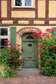 Roses blooming in front of a half-timbered house