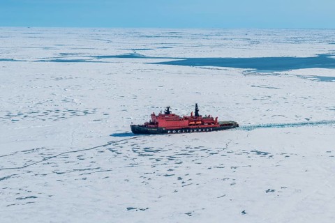 Aerial of the Icebreaker '50 years of victory' on its way to the North Pole breaking through the ice