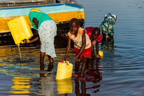 Children filling water in canisters at Lake Albert