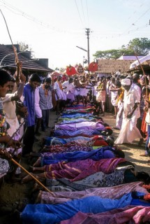Poojari or priest walking on women in Mahasivaratri festival at poochiyur near Coimbatore