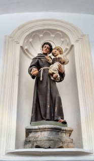 Saint figure with Jesus child and bread