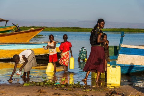 Children filling water in canisters at Lake Albert