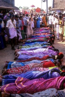 Poojari or priest walking on women in Mahasivaratri festival at poochiyur near Coimbatore
