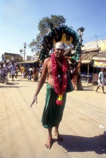 A sadhu carrying Kavadi on his shoulder to Palani on Thai Poosam day