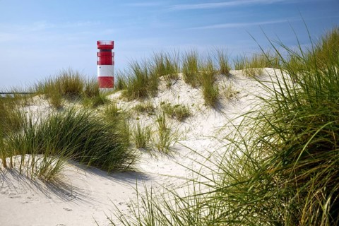 Dune landscape with the lighthouse at the south beach of the island Duene