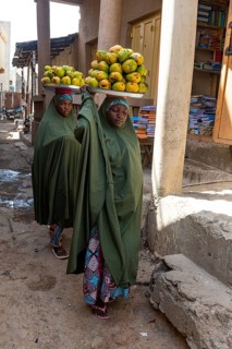 Women carrying fruits on their head