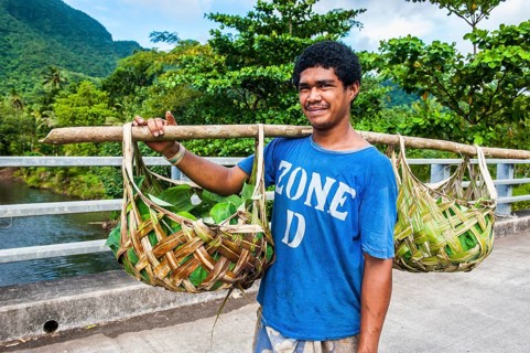 Local farmer bringing his goods in palm baskets back home