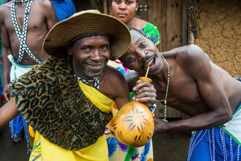 Friendly men drinkin local beer on a Ceremony of former poachers